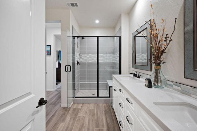 bathroom featuring vanity and a shower with shower door