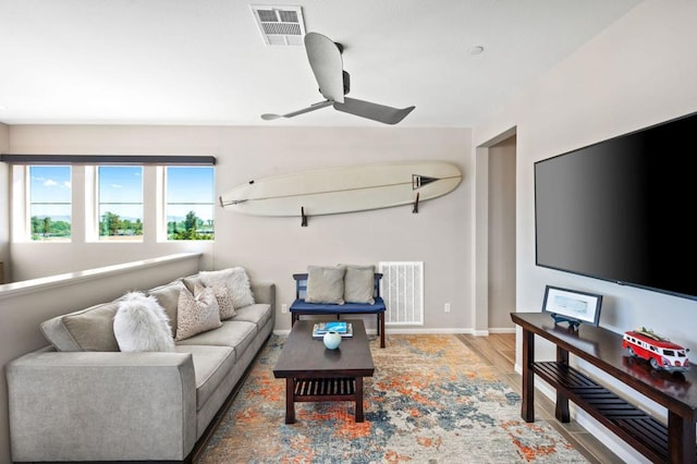 living room featuring hardwood / wood-style floors and ceiling fan