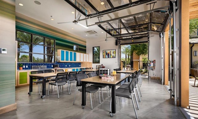 dining area with concrete floors and ceiling fan