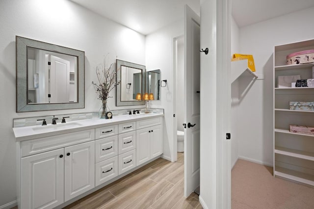 bathroom featuring vanity, toilet, and hardwood / wood-style floors