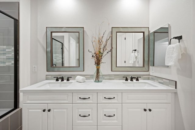 bathroom with vanity and a shower with door