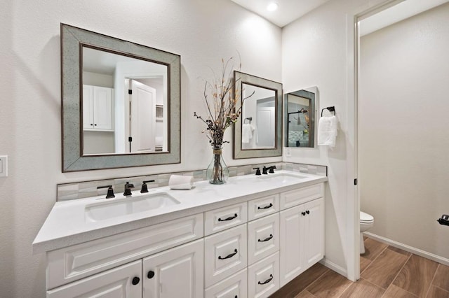 bathroom with vanity, hardwood / wood-style flooring, and toilet