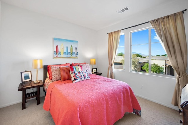 bedroom featuring light carpet