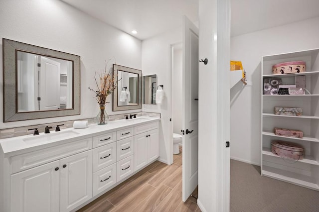 bathroom with vanity, hardwood / wood-style floors, and toilet