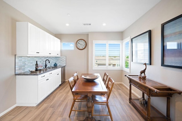 dining room featuring sink and a wealth of natural light