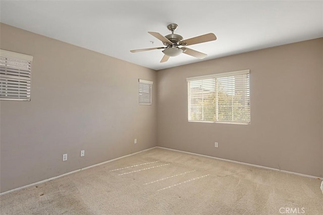 spare room with light carpet and ceiling fan