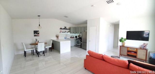 tiled living room with vaulted ceiling and sink