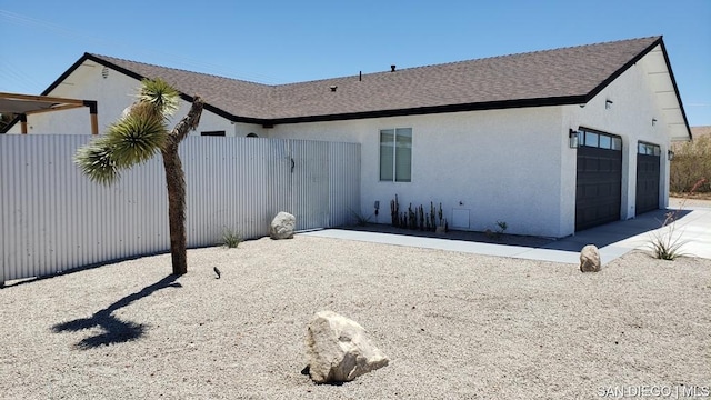 rear view of house with a garage