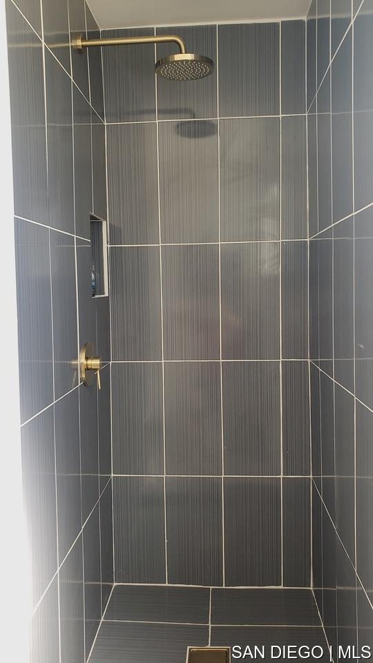 bathroom with tiled shower