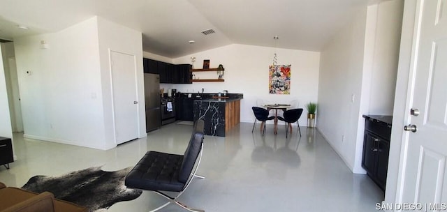 kitchen with lofted ceiling and appliances with stainless steel finishes