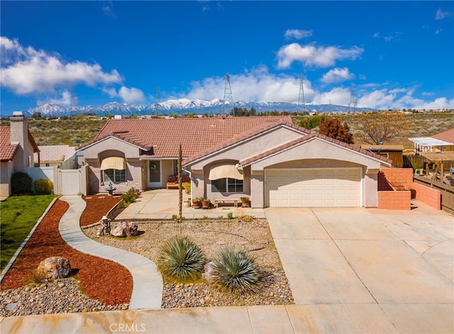 view of front of property featuring a garage and a mountain view