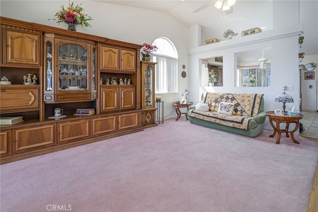 living room featuring high vaulted ceiling, light colored carpet, and ceiling fan