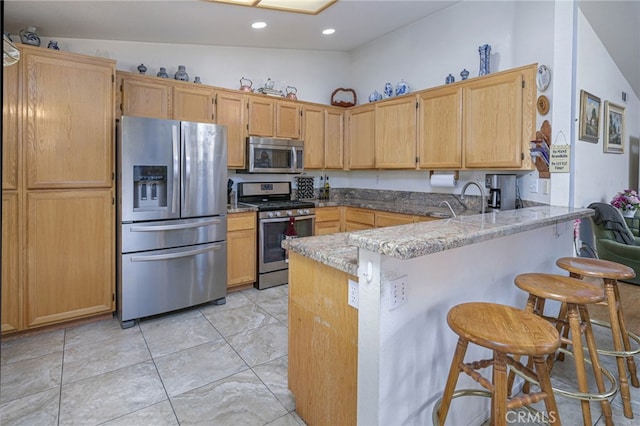14329 Stone Creek Trl, Hesperia, CA 92344 - kitchen featuring high vaulted ceiling, kitchen peninsula, a breakfast bar area, stainless steel appliances, and light tile floors