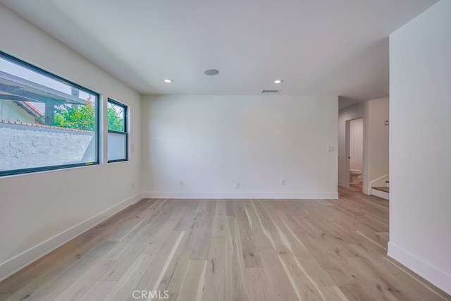 unfurnished room with light wood-type flooring