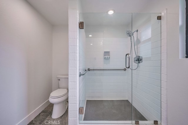 bathroom featuring walk in shower, toilet, and tile patterned flooring