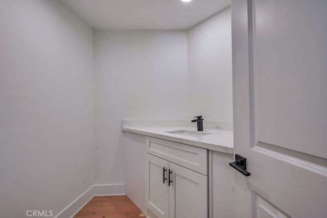 bathroom with hardwood / wood-style floors and vanity