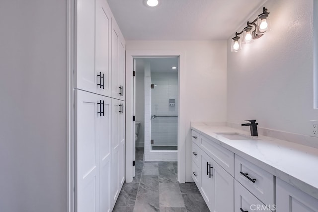 bathroom featuring vanity and an enclosed shower