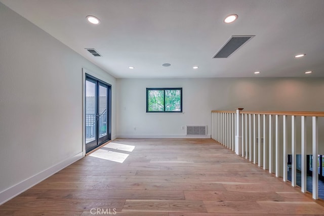 unfurnished room with hardwood / wood-style flooring