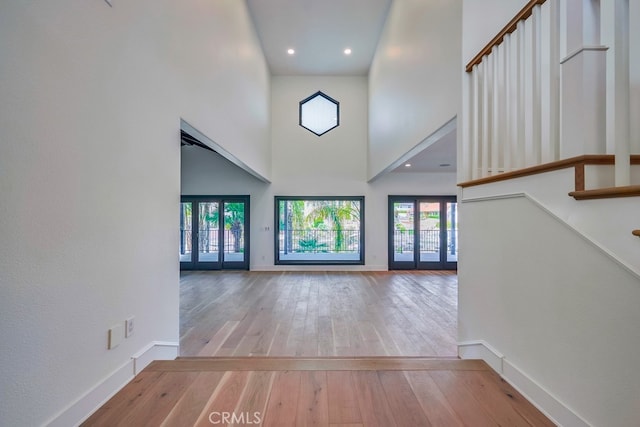 entryway featuring a high ceiling and hardwood / wood-style floors