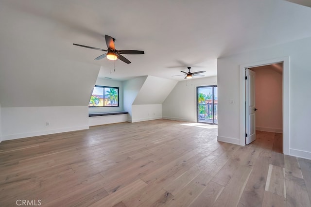 bonus room featuring plenty of natural light, ceiling fan, vaulted ceiling, and light hardwood / wood-style floors