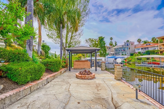 view of home's community with a patio and an outdoor fire pit