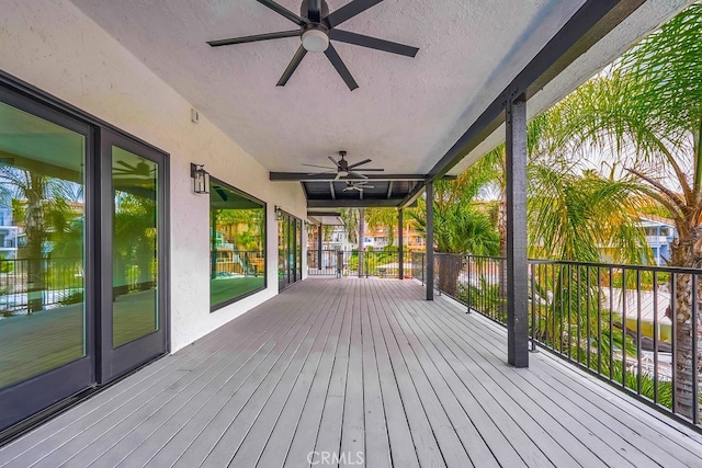 wooden deck featuring ceiling fan