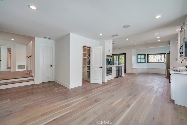 unfurnished living room with light hardwood / wood-style floors