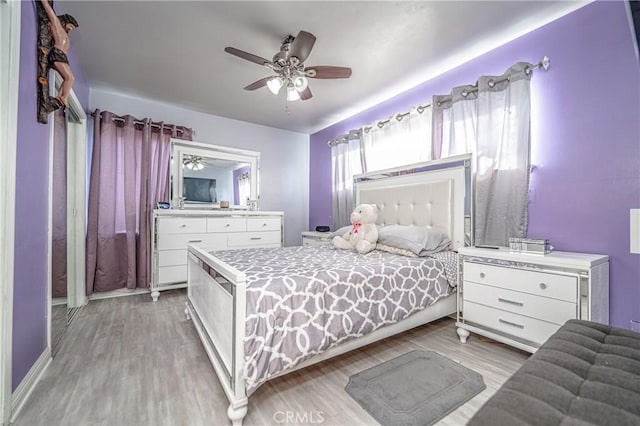 bedroom with light wood-type flooring and ceiling fan