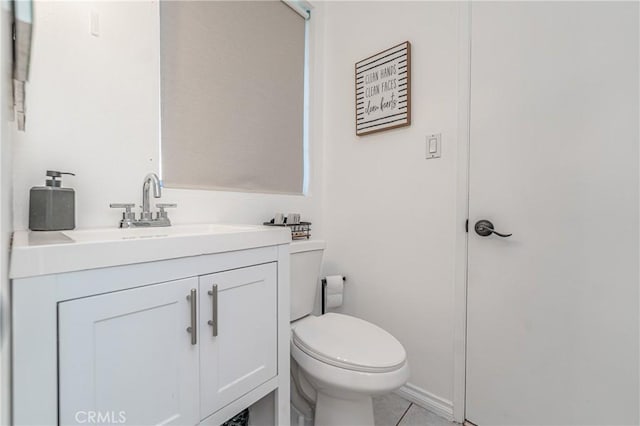 bathroom featuring tile patterned floors, vanity, and toilet