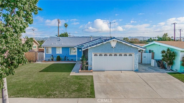 single story home featuring a garage and a front yard