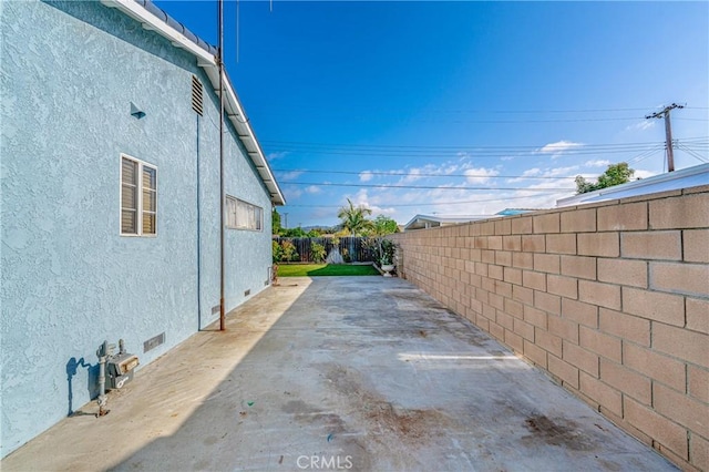 view of side of property featuring a patio