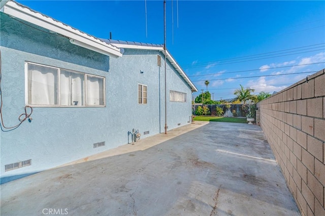 view of side of property featuring a patio