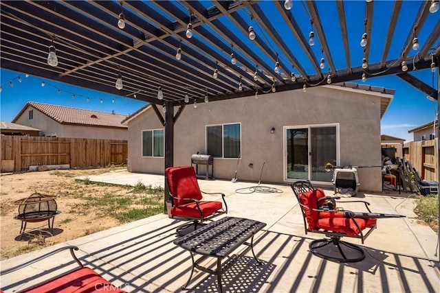 view of patio with a fire pit and a pergola