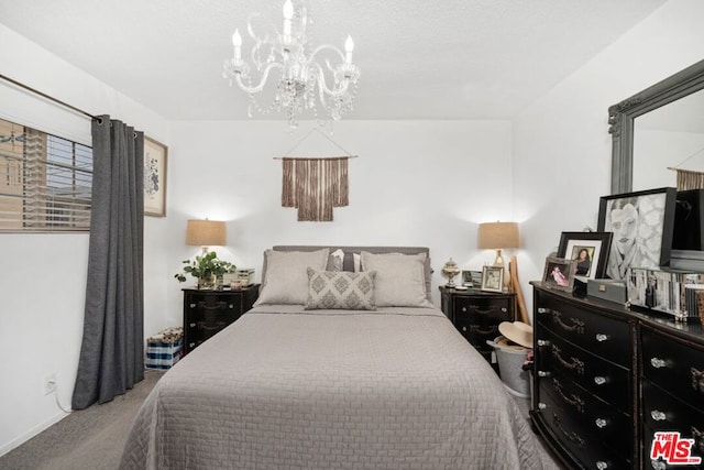 carpeted bedroom with a notable chandelier