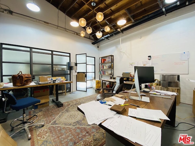 office featuring concrete floors and a high ceiling