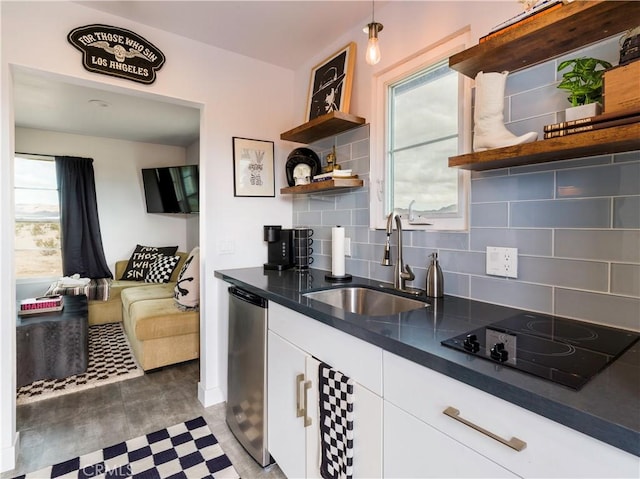 kitchen featuring white cabinets, black electric cooktop, stainless steel dishwasher, and a healthy amount of sunlight