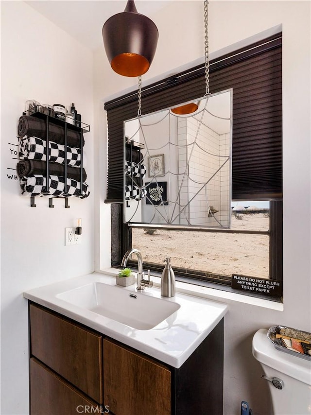 bathroom featuring vanity and toilet