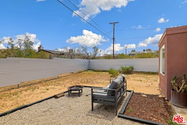 view of yard with a fire pit