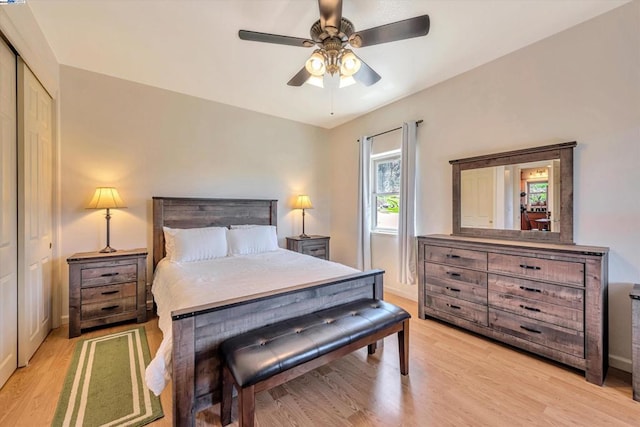 bedroom featuring light hardwood / wood-style floors, a closet, and ceiling fan