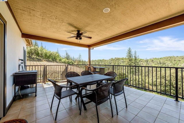 view of patio / terrace with a balcony and ceiling fan