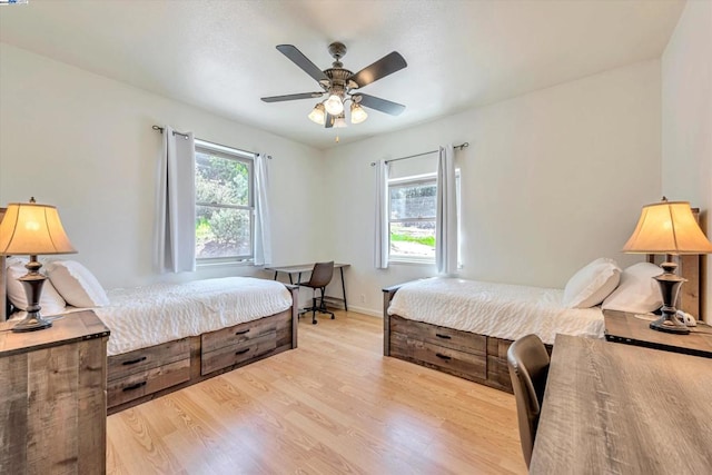 bedroom with ceiling fan and light wood-type flooring