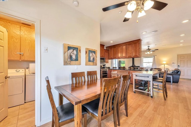 dining area featuring light hardwood / wood-style flooring, washer and dryer, and ceiling fan