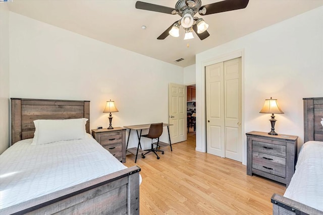 bedroom featuring light hardwood / wood-style flooring, a closet, and ceiling fan