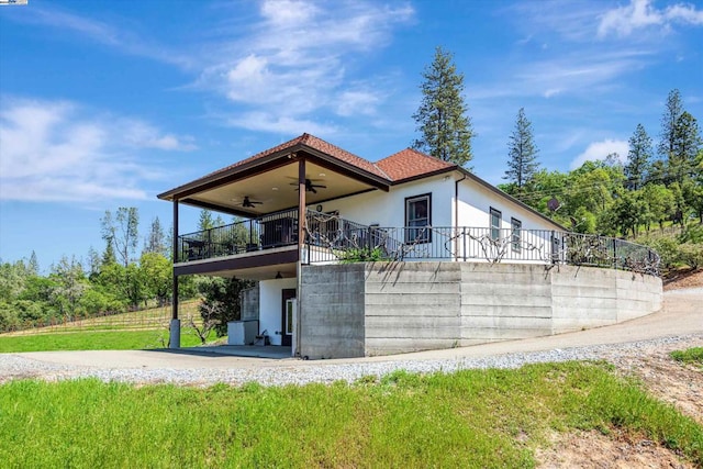 rear view of property with a patio and ceiling fan