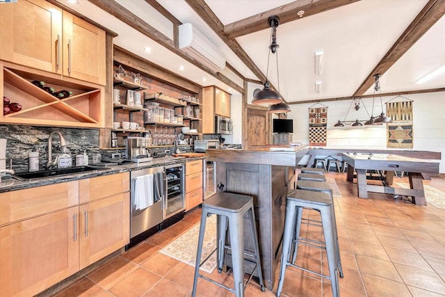 kitchen with sink, stainless steel appliances, beamed ceiling, and decorative light fixtures