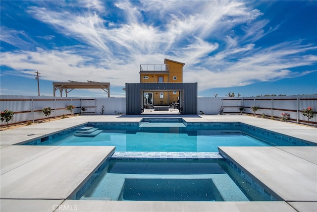 view of pool featuring a patio and an in ground hot tub