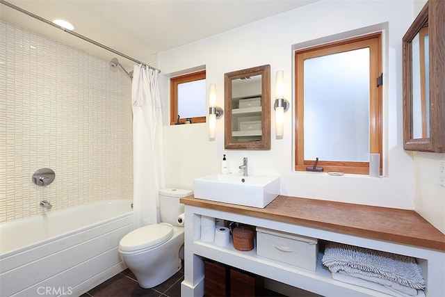 full bathroom featuring tile patterned flooring, vanity, toilet, and shower / tub combo with curtain