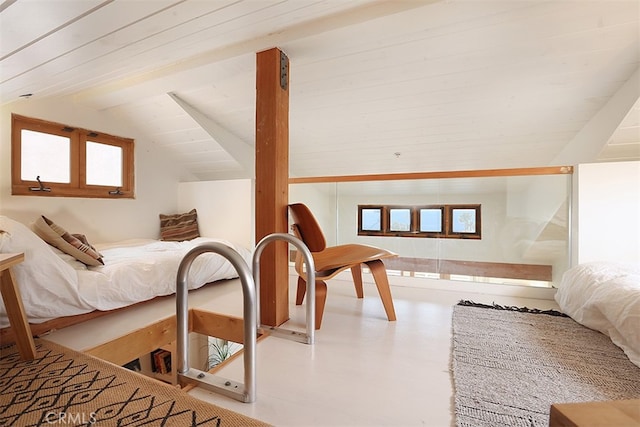 bedroom with vaulted ceiling with beams and multiple windows