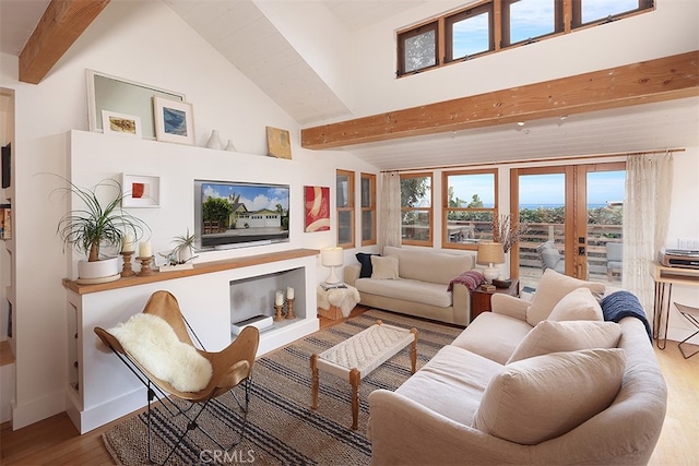 living room featuring hardwood / wood-style flooring, beam ceiling, high vaulted ceiling, and french doors