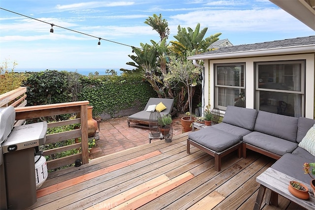 wooden terrace featuring outdoor lounge area and a patio